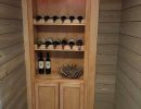 Wine rack remodel with wooden racks and cabinet.